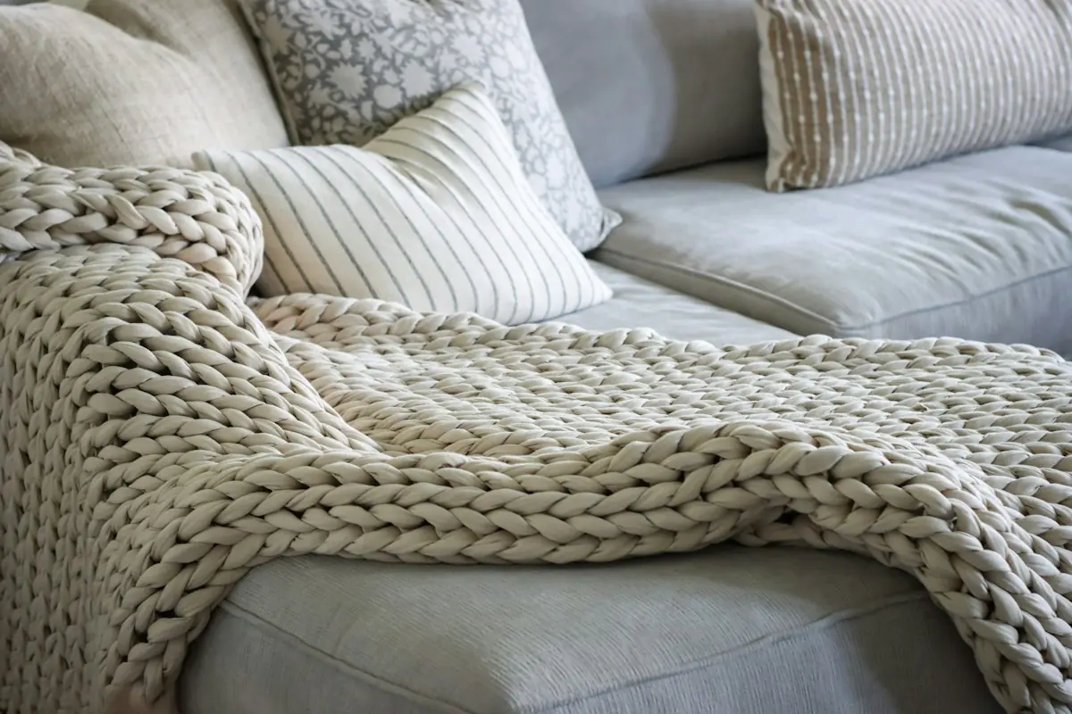 Woven blanket draped over a sofa