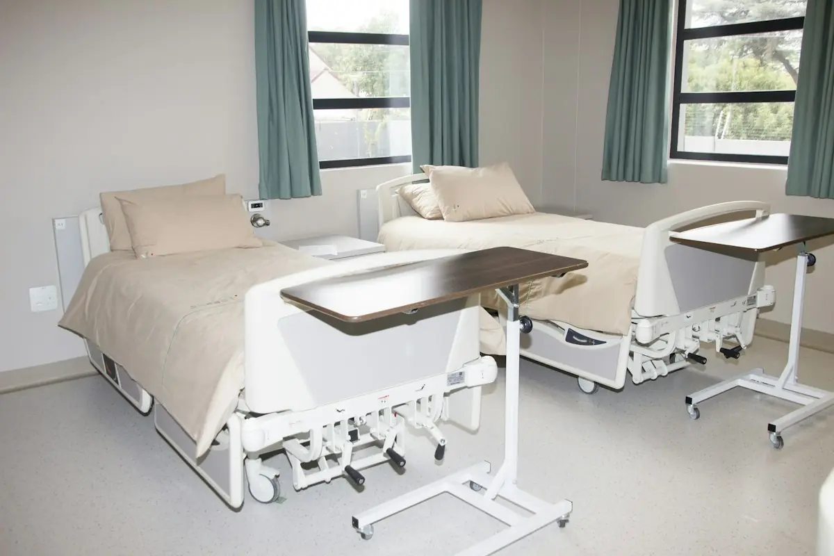 White hospital bed near a window