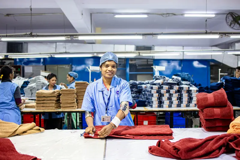 Workers folding towels in a textile factory
