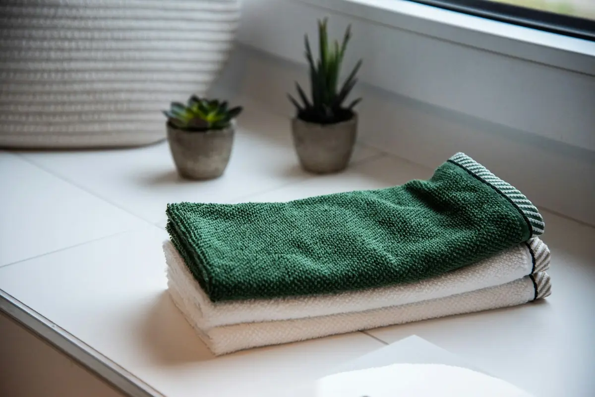Folded bath towels stacked on a shelf